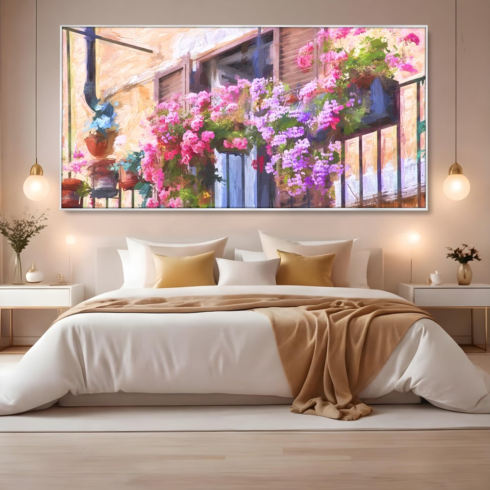 Tablou canvas cu pictura cu balcon plin de flori roz, in rama de aluminiu argintiu, pe perete intr-un dormitor